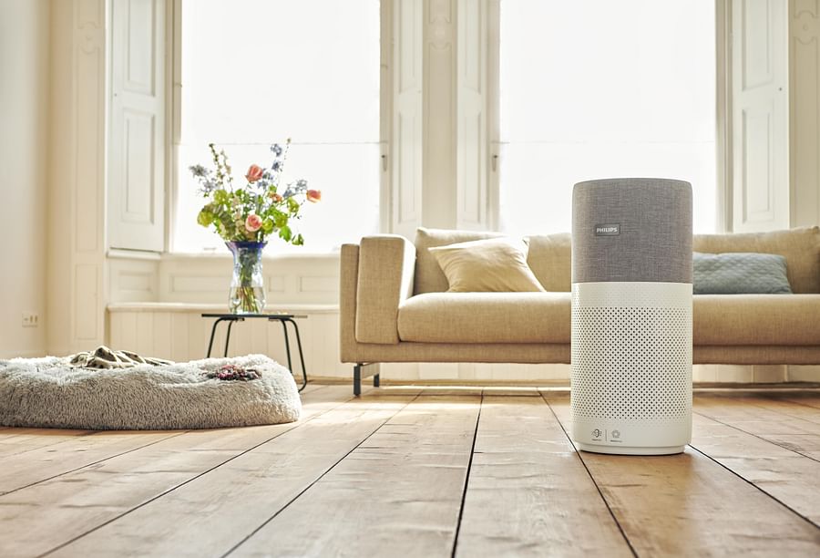 Air Doctor Air Purifier on a table with a clean, fresh living room in the background